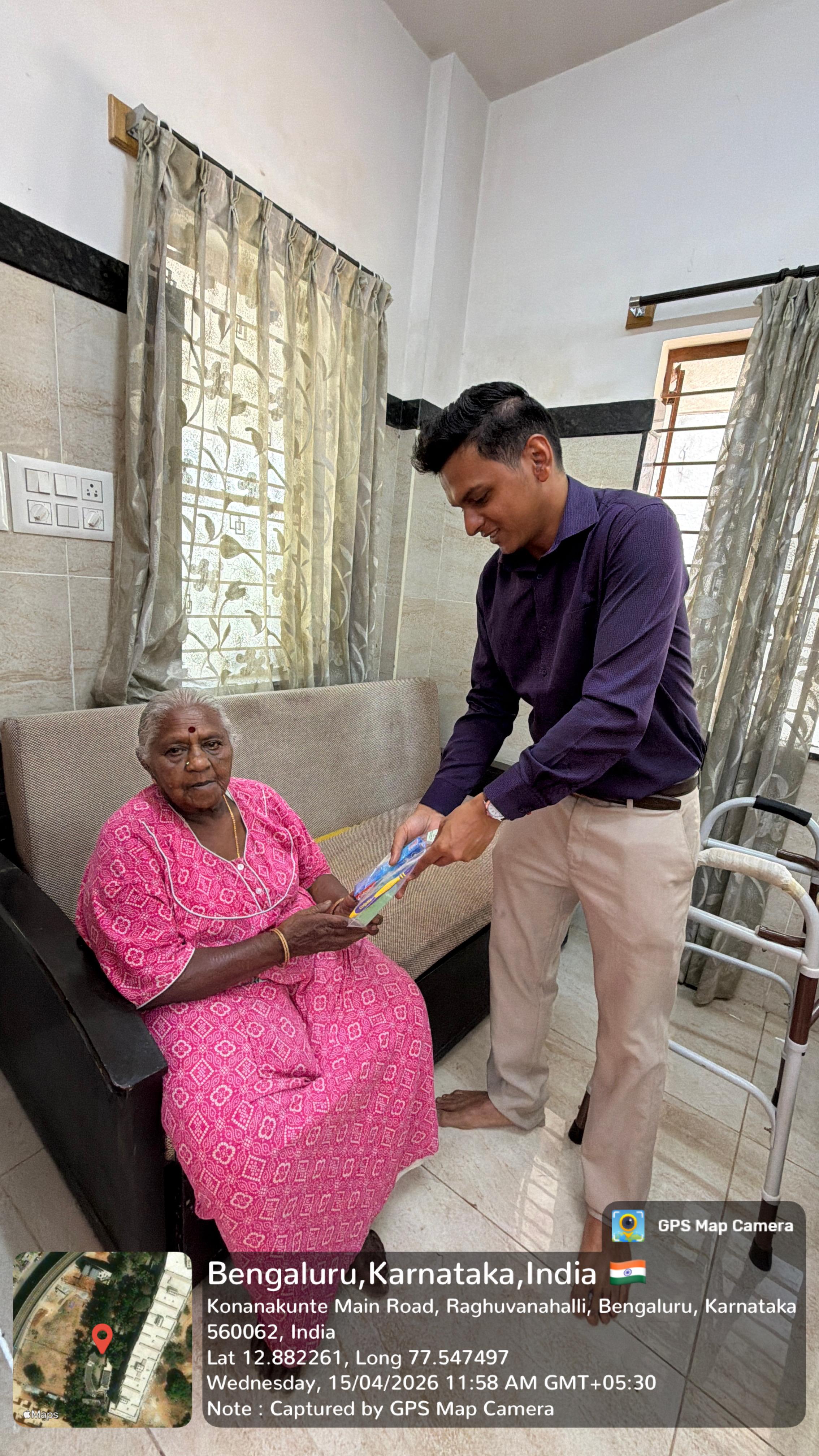 Volunteer distributing hygiene kits to an elderly resident