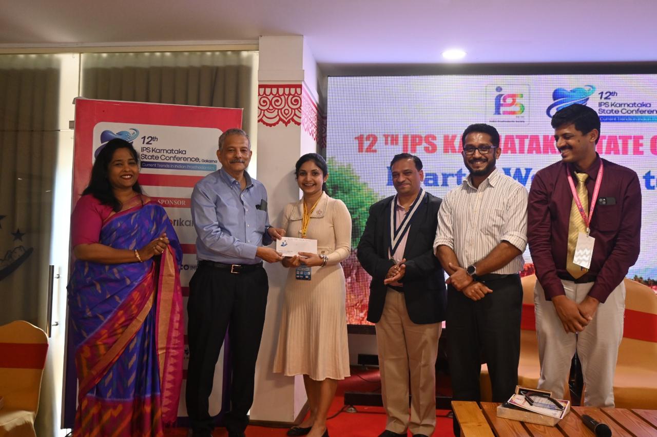 Dr. Samantha Rasquinha receiving First Prize in Overall Best Paper category