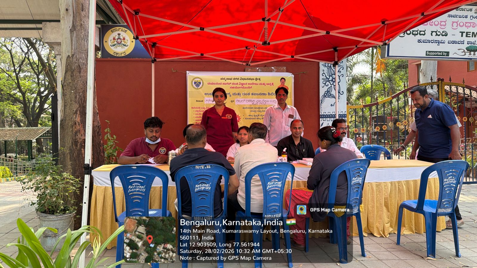 Dental professionals interacting with patients, 'National Periodontist Day' banner in background