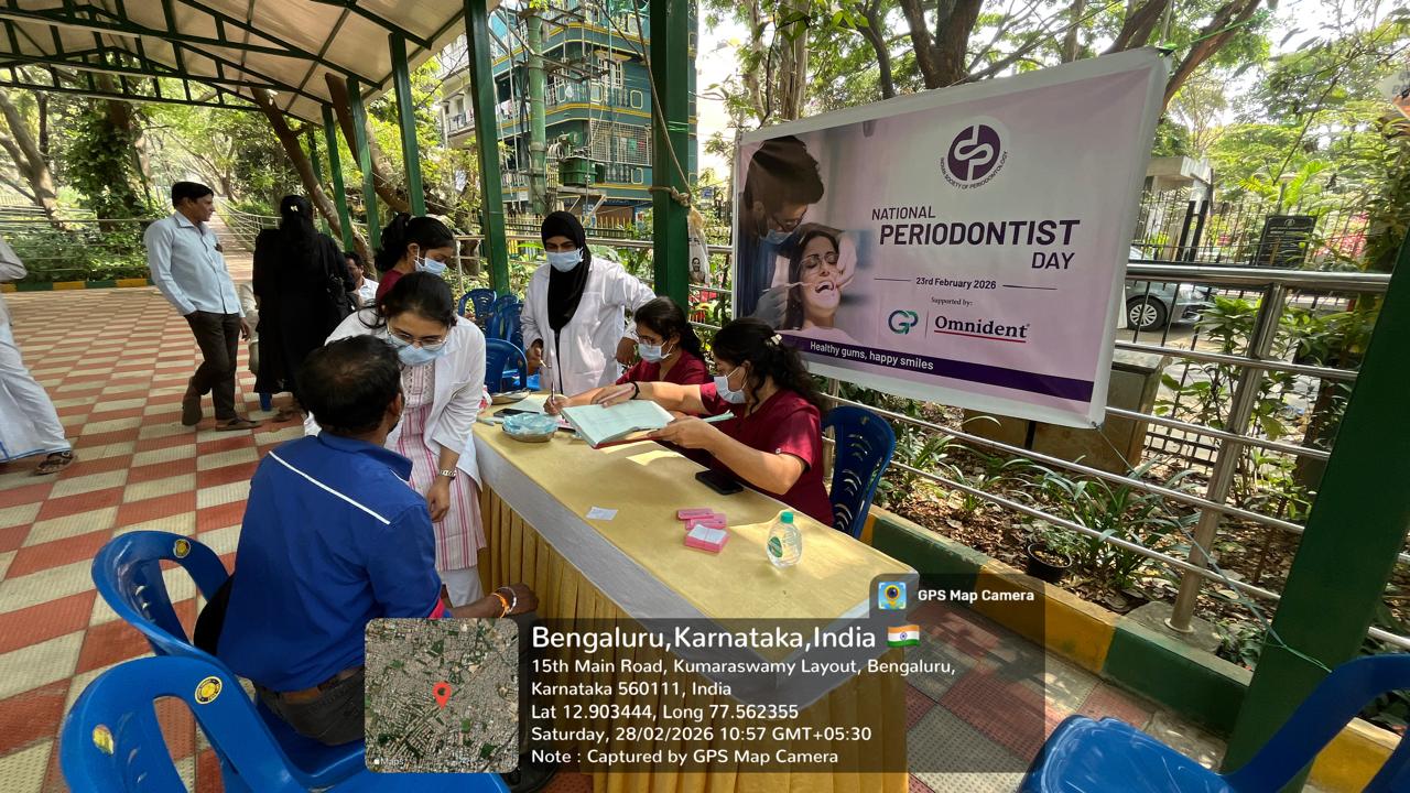 Camp setup with a red tent, showing organizers and patients at a table for BP and RBS examination
