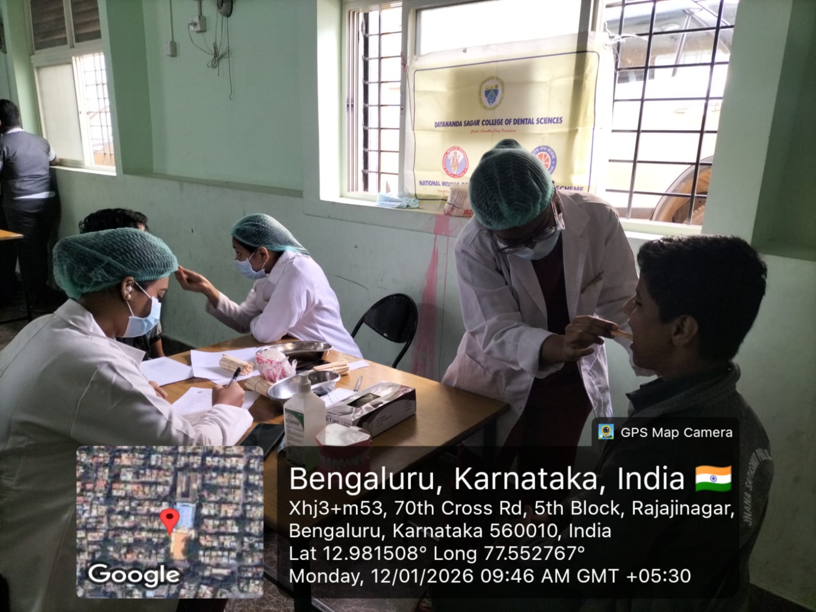 Dental team members interacting with patients at the camp