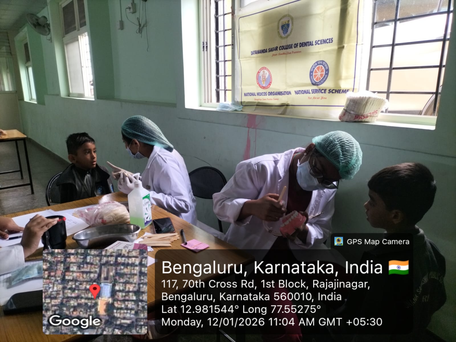 Dentist providing oral health education to a child using a dental model