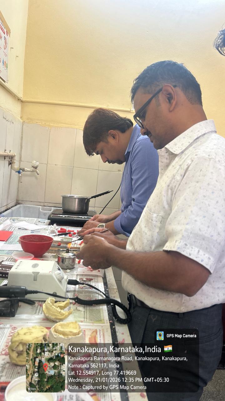 Faculty and students posing with the 'Prosthodontist Day' banner.