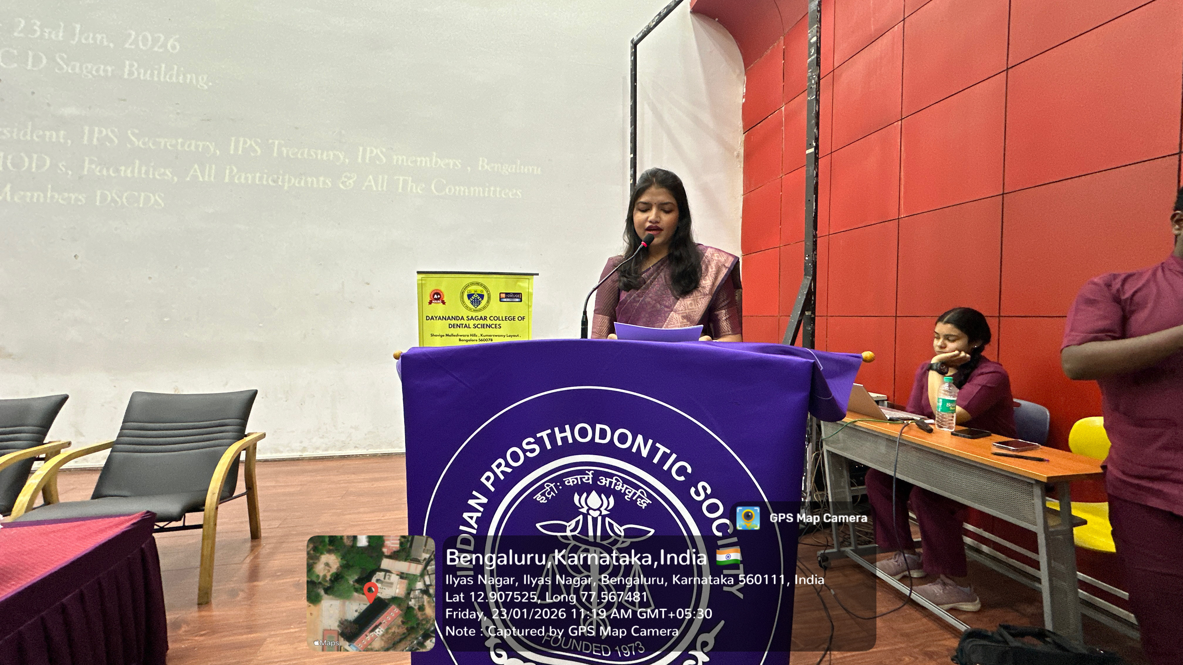 Speaker addressing the audience at the podium