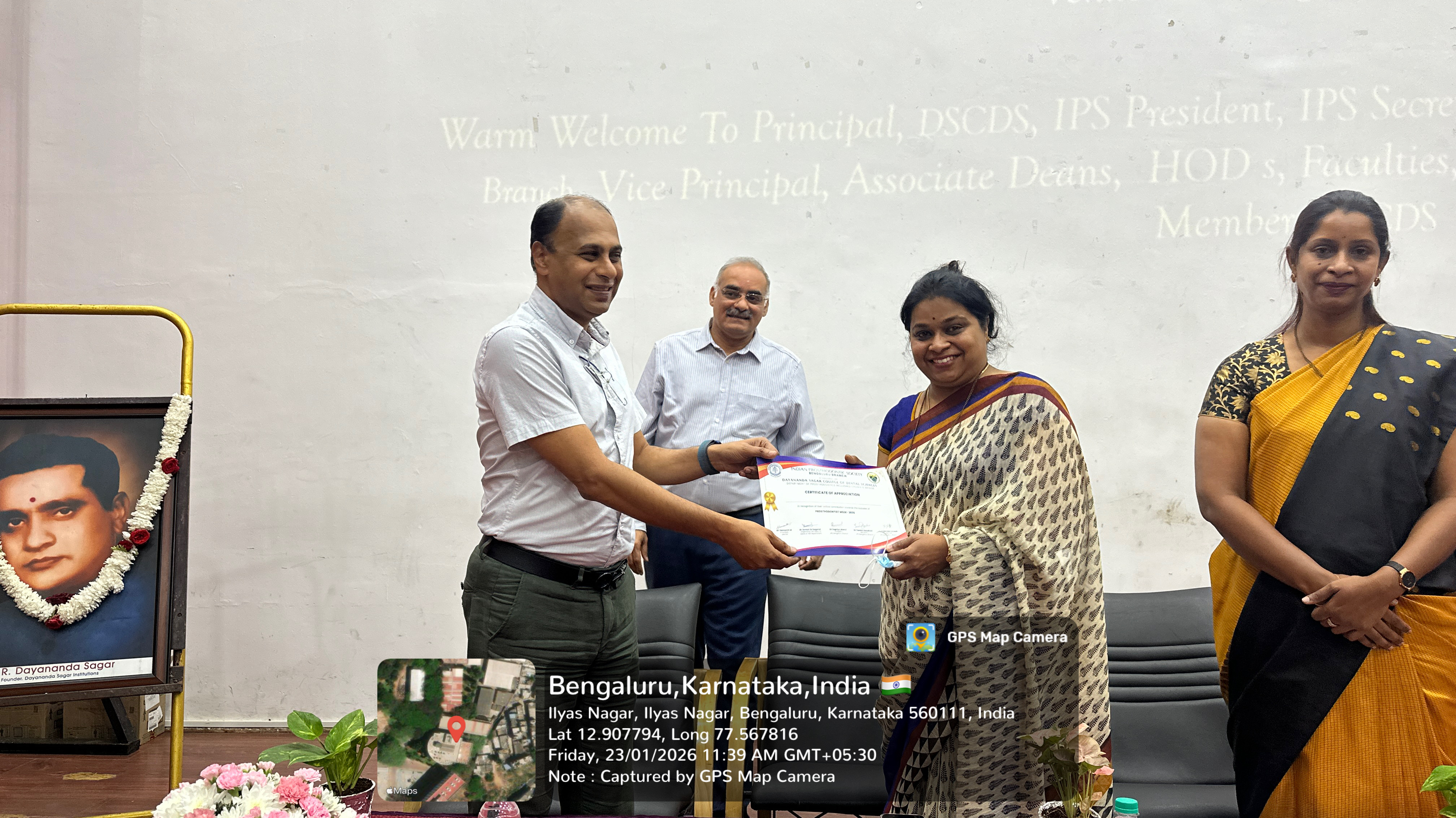 Dignitary presenting a certificate to a faculty member