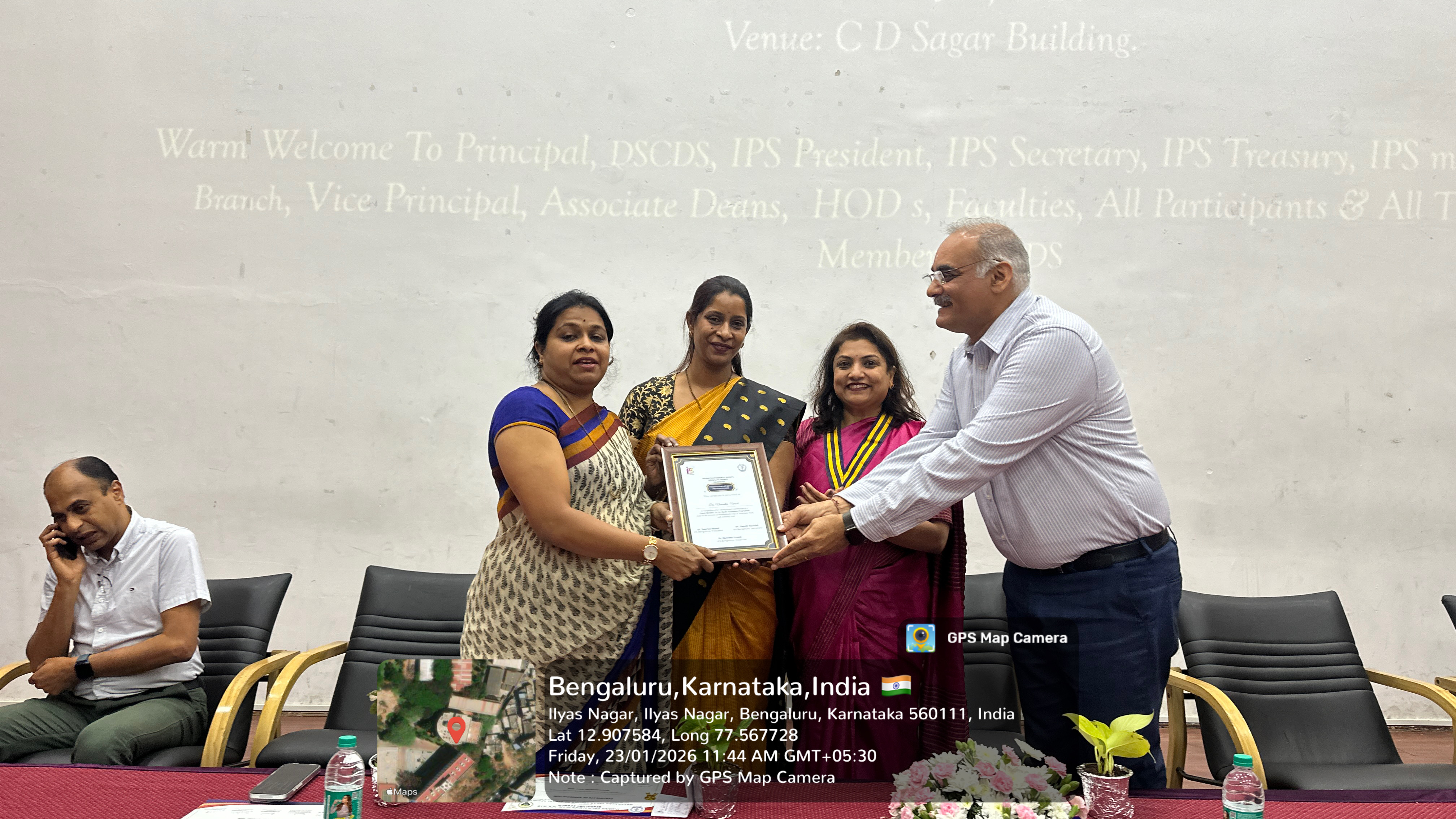 Faculty member receiving a token of appreciation