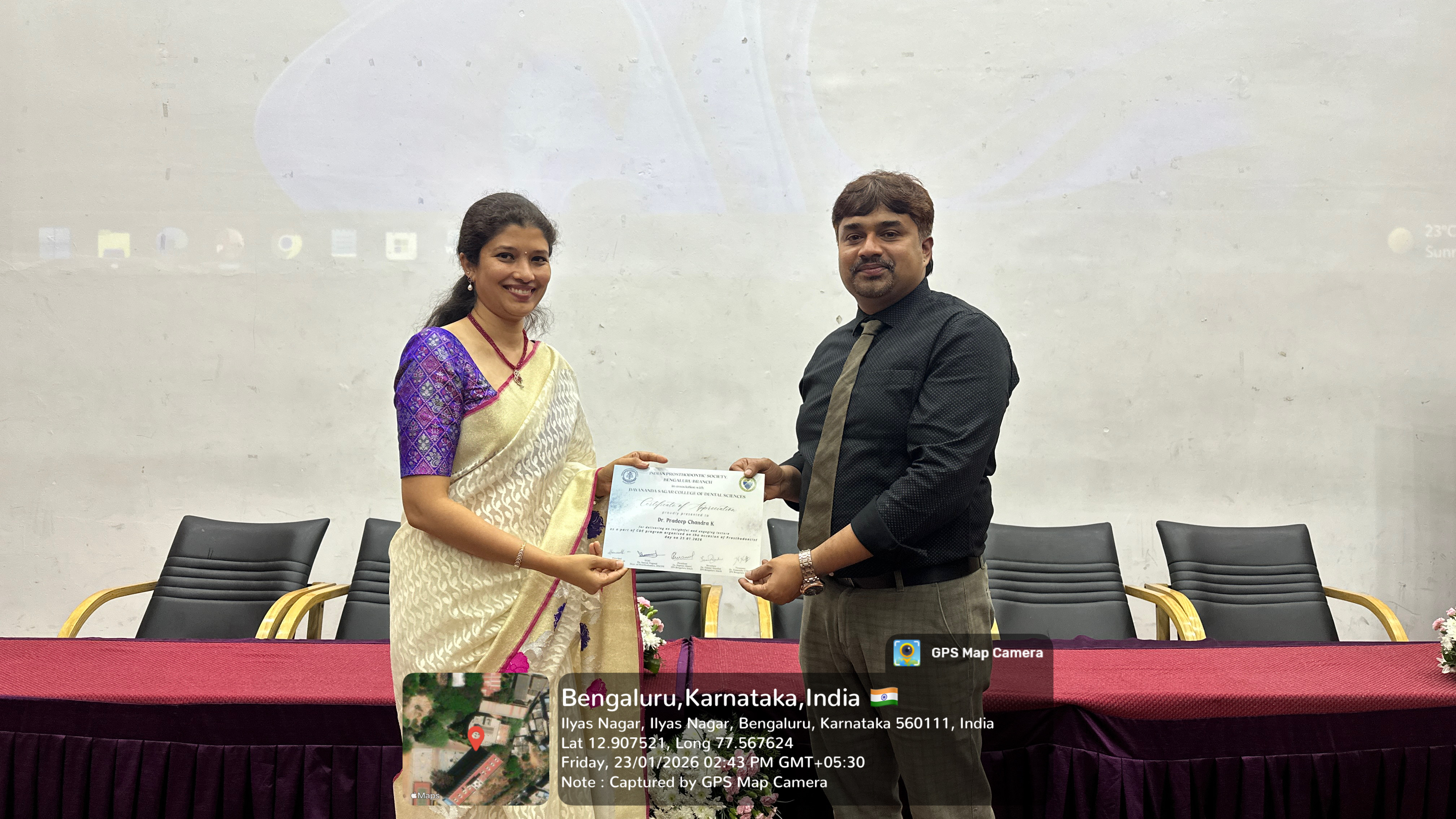 Dr. Pradeep Chandra K receiving a certificate