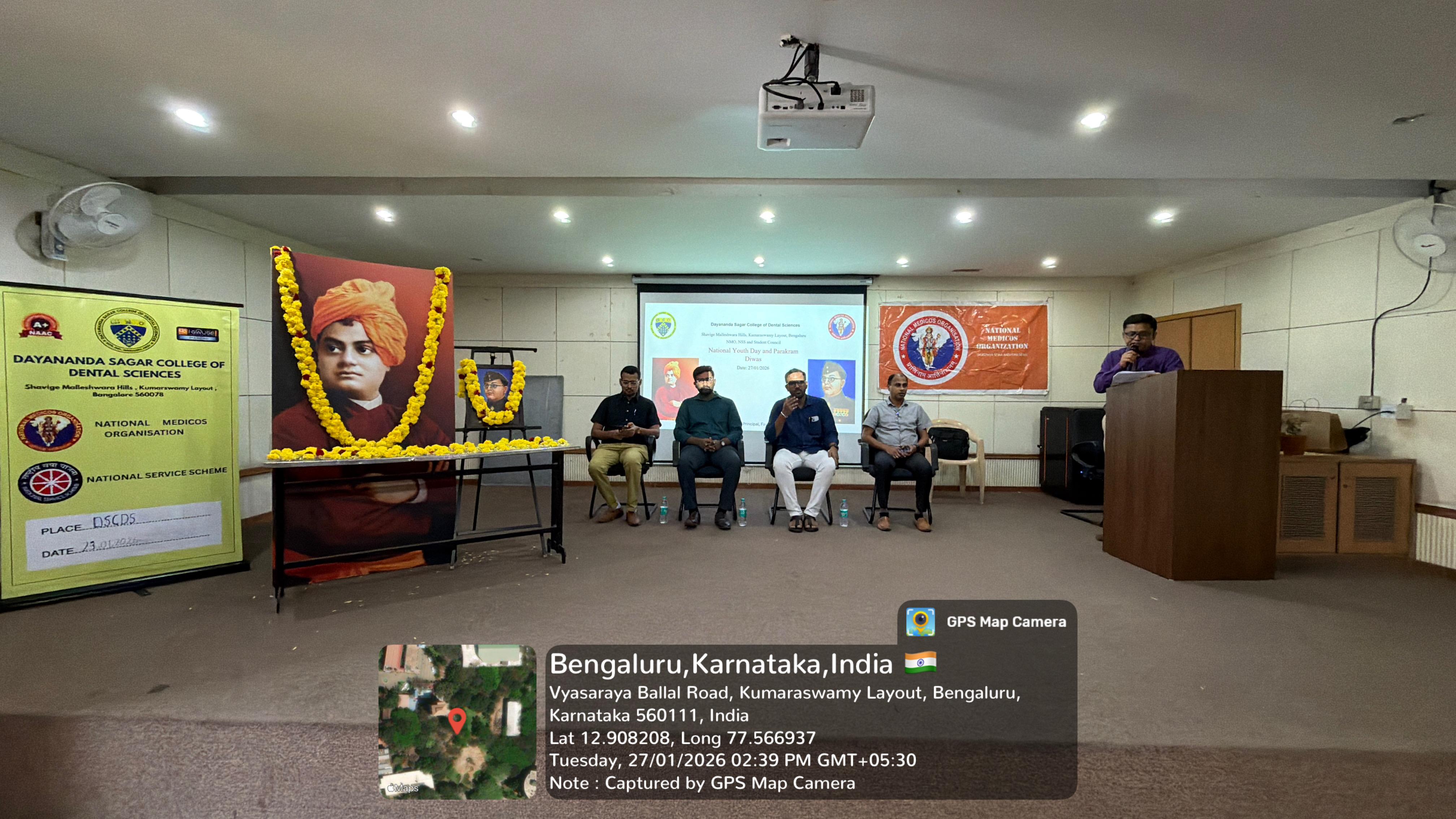 A faculty member presenting a token of appreciation to a guest