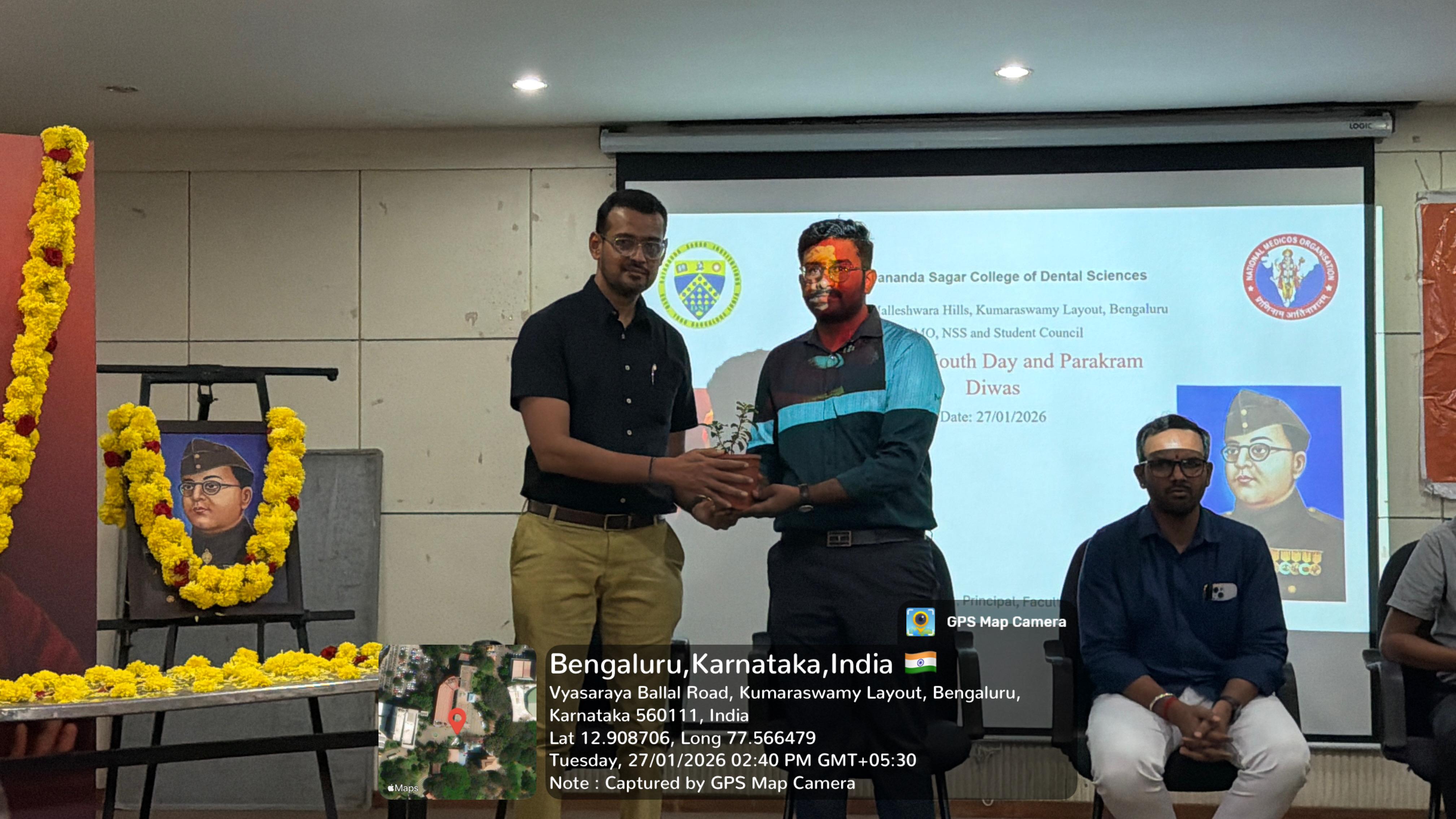 A faculty member presenting a token of appreciation to a guest