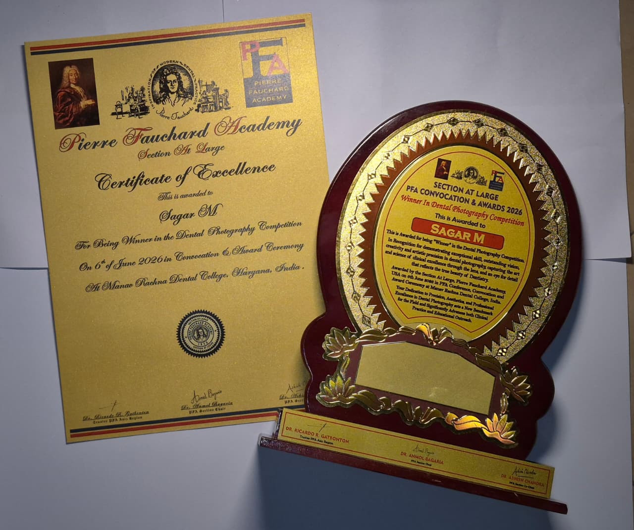 Certificate and trophy awarded to Sagar M for Dental Photography Competition