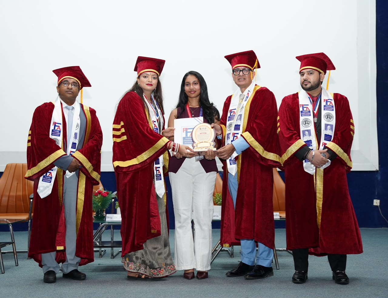 Nicole Lasrado receiving the Dental Art Competition award from faculty