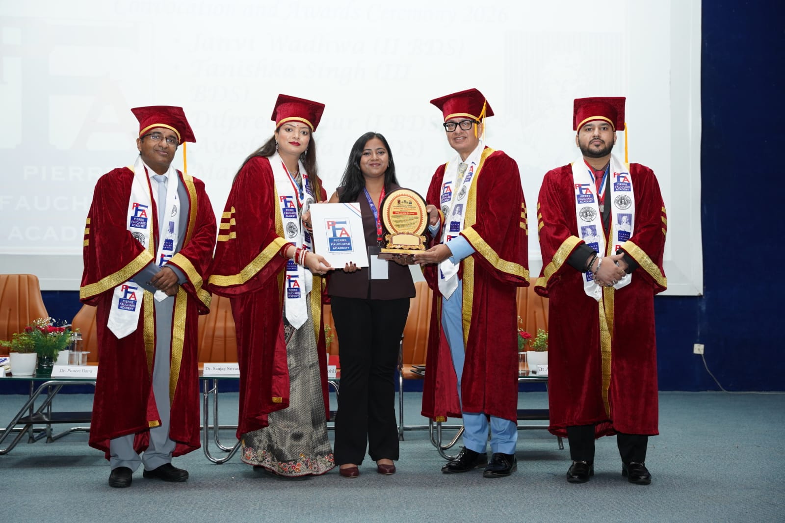 Sagar M receiving the Dental Photography Competition award from faculty